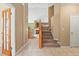 Tiled entryway featuring a staircase, a stained-glass door, and a partial view of the living room at 21690 Longs Peak Ln, Parker, CO 80138