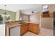 Spacious kitchen with bar seating, opening to the living area and staircase at 21690 Longs Peak Ln, Parker, CO 80138