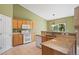 Bright kitchen featuring tile floors, wooden cabinetry, and stone countertops at 21690 Longs Peak Ln, Parker, CO 80138