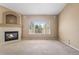 Bright living room featuring a fireplace, neutral walls, carpet floors and large picture window with outdoor views at 21690 Longs Peak Ln, Parker, CO 80138