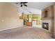 Open living room with fireplace, carpet, and view to the kitchen at 21690 Longs Peak Ln, Parker, CO 80138
