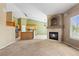 Open living room with fireplace, a view to the kitchen, and carpet at 21690 Longs Peak Ln, Parker, CO 80138