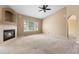 Spacious living room with fireplace, a ceiling fan, and large window at 21690 Longs Peak Ln, Parker, CO 80138