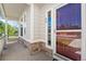 Close up view of a charming covered porch, stone accents, and inviting entrance at 21690 Longs Peak Ln, Parker, CO 80138