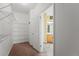 Walk-in closet with white walls, carpet and wire shelving, plus a partial view into an adjacent bathroom at 21690 Longs Peak Ln, Parker, CO 80138