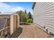 A well-maintained yard with a storage shed and gravel pathway along the side of the house at 21690 Longs Peak Ln, Parker, CO 80138