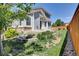 Landscaped backyard with stone retaining walls, green grass, and views of the home's exterior at 20394 E Colgate Pl, Aurora, CO 80013