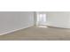 Spacious basement with a window and neutral carpet, creating a versatile area for recreation, storage, or customization at 20394 E Colgate Pl, Aurora, CO 80013