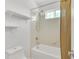 Bright bathroom showcasing a shower-tub combo with sleek fixtures, complemented by organized shelving, for a calming and functional space at 20394 E Colgate Pl, Aurora, CO 80013