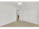 Well-lit bedroom showcasing neutral walls, plush carpet, and closet, complemented by an open doorway for easy accessibility at 20394 E Colgate Pl, Aurora, CO 80013