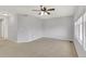 Bright living room with neutral walls, carpet, ceiling fan, and natural light from windows, perfect for relaxing or entertaining at 20394 E Colgate Pl, Aurora, CO 80013