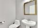 A quaint powder room showcasing a pedestal sink and commode at 20394 E Colgate Pl, Aurora, CO 80013