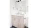 Modern bathroom vanity with sleek hardware, bright lighting, and a decorative floral accent at 12555 W 10Th Ave, Golden, CO 80401