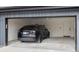 Spacious garage interior with a parked SUV and a service door for easy access at 12555 W 10Th Ave, Golden, CO 80401