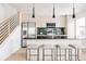 Modern kitchen features stainless steel appliances, a breakfast bar with stools, and stylish pendant lighting at 12555 W 10Th Ave, Golden, CO 80401