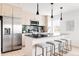 Bright, modern kitchen with stainless steel appliances, a large island with seating, and sleek pendant lights at 12555 W 10Th Ave, Golden, CO 80401