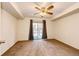 Bright bedroom with a ceiling fan and sliding door to patio at 1885 S Quebec Way # 16, Denver, CO 80231