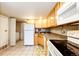 Kitchen with white appliances and wood cabinets at 1885 S Quebec Way # 16, Denver, CO 80231