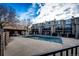 Community pool area with a covered patio and surrounding buildings at 1885 S Quebec Way # 16, Denver, CO 80231