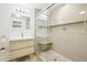 Bathroom with glass shower, wooden vanity with sink, and recessed lighting at 12638 James Pt, Broomfield, CO 80020
