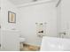 Bathroom with a toilet, sink, towel rack, and artwork on the wall at 12638 James Pt, Broomfield, CO 80020