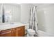 Bright bathroom featuring a shower-tub combination and wood vanity cabinet at 12638 James Pt, Broomfield, CO 80020