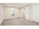 Bedroom with carpet, an entrance to a bathroom, a door to closet and a hallway at 12638 James Pt, Broomfield, CO 80020