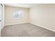Bedroom with carpet, one window, and a white door at 12638 James Pt, Broomfield, CO 80020