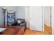 This is a home office with neutral walls, wood floors, a leather chair, and built in shelves at 12638 James Pt, Broomfield, CO 80020