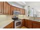 Well-lit kitchen featuring stainless steel appliances, light countertops, and warm wood cabinetry at 12638 James Pt, Broomfield, CO 80020