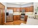 Well-equipped kitchen with stainless steel appliances, warm wood cabinetry, and ample counter space at 12638 James Pt, Broomfield, CO 80020