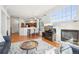 Open-concept living room featuring a fireplace, hardwood floors and access to the kitchen at 12638 James Pt, Broomfield, CO 80020