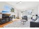 Bright living room with large windows, fireplace, hardwood floors and comfortable seating at 12638 James Pt, Broomfield, CO 80020
