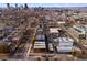 Expansive urban landscape showcases modern residences with Denver skyline backdrop and mature trees at 3275 Lawrence St, Denver, CO 80205