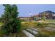 A serene community park featuring lush greenery, wildflowers, a mural and shaded seating at 3275 Lawrence St, Denver, CO 80205