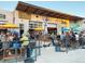 An exterior shot of a trendy building with outdoor seating, vibrant murals, and a lively atmosphere at 3275 Lawrence St, Denver, CO 80205