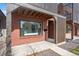 Attractive brick home exterior with a welcoming porch and modern architectural details at 3275 Lawrence St, Denver, CO 80205