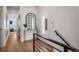 Hallway featuring modern design elements, a stylish mirror, and hardwood floors at 3275 Lawrence St, Denver, CO 80205