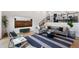 Comfortable living room featuring modern decor, a large sectional sofa, and hardwood floors at 3275 Lawrence St, Denver, CO 80205