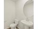 Simple and clean bathroom with pedestal sink and oval mirror at 20972 E 66Th Ave, Aurora, CO 80019