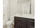 Clean bathroom, featuring dark brown vanity and a white toilet at 20972 E 66Th Ave, Aurora, CO 80019