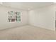 Well-lit bedroom with carpeted floor and window at 20972 E 66Th Ave, Aurora, CO 80019