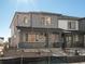 Two-story home with stone and gray siding, front porch, and landscaping at 20972 E 66Th Ave, Aurora, CO 80019