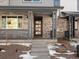 Modern front entrance with stone accents and glass door at 20972 E 66Th Ave, Aurora, CO 80019