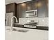 Modern kitchen with stainless steel appliances and white quartz countertops at 20972 E 66Th Ave, Aurora, CO 80019