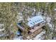 Secluded mountain house with skylights and a large outdoor deck, surrounded by pine trees at 21191 Pleasant Park Rd, Conifer, CO 80433