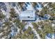 Overhead aerial view of snow covered roof of mountain home surrounded by snow covered pine trees at 21191 Pleasant Park Rd, Conifer, CO 80433