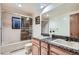 Bathroom with a double sink vanity and shower over bath combo at 21191 Pleasant Park Rd, Conifer, CO 80433