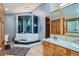Bathroom with tiled floors, modern steam shower, and a wood cabinet vanity at 21191 Pleasant Park Rd, Conifer, CO 80433
