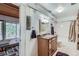 Bathroom includes a single vanity and a shower-over-tub combination next to a sunroom at 21191 Pleasant Park Rd, Conifer, CO 80433